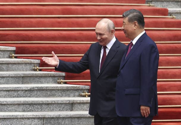 China-Russia summit Russian President Vladimir Putin (L) attends a welcoming ceremony with Chinese President Xi Jinping at the Great Hall of the People in Beijing ahead of their summit meeting on May 20, 2026. (Pool photo)  A14AA0005587102P