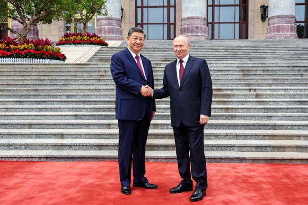 CHINA, BEIJING - MAY 20, 2026: Xi Jinping (L), President of China, and his counterpart Vladimir Putin of Russia shake hands during a welcoming ceremony in Tiananmen Square. Putin s official visit marks 25 years since the 2001 Treaty of Good Neighbourliness and Friendly Cooperation between Russia and China. Alexander Kazakov Russian Presidential Press and Information Office TASS  92770306