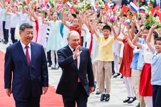 CHINA, BEIJING - MAY 20, 2026: Xi Jinping, President of China, and his counterpart Vladimir Putin (L-R) of Russia enjoy a welcoming ceremony in Tiananmen Square. Putin s official visit marks 25 years since the 2001 Treaty of Good Neighbourliness and Friendly Cooperation between Russia and China. Alexander Kazakov Russian Presidential Press and Information Office TASS  92770975