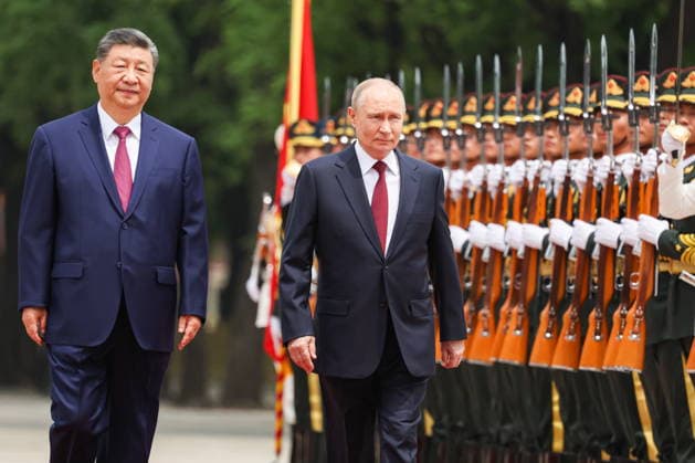 CHINA, BEIJING - MAY 20, 2026: Xi Jinping, President of China, and his counterpart Vladimir Putin (L-R) of Russia walk past honour guards during a welcoming ceremony in Tiananmen Square. Putin s official visit marks 25 years since the 2001 Treaty of Good Neighbourliness and Friendly Cooperation between Russia and China. Alexander Kazakov Russian Presidential Press and Information Office TASS  92771000