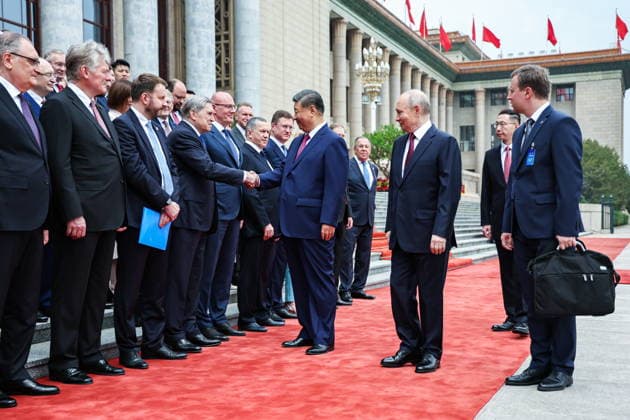 CHINA, BEIJING - MAY 20, 2026: Vladimir Putin, President of Russia, his counterpart Xi Jinping (R-L centre) of China, Russia s Ambassador Igor Morgulov, Presidential Press Secretary Dmitry Peskov, Maxim Oreshkin, Deputy Chief of Staff, Presidentia Executive Office, Presidential Aide Yuri Ushakov, Deputy Prime Ministers Dmitry Chernyshenko and Alexander Novak (L-R front) shake hands during a welcoming ceremony in Tiananmen Square. Putin s official visit marks 25 years since the 2001 Treaty of Good Neighbourliness and Friendly Cooperation between Russia and China. Alexander Kazakov Russian Presidential Press and Information Office TASS  92771217