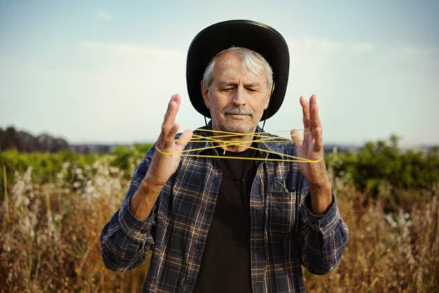 Happy man with yellow thread in countryside field Ra anana, Center District, Israel CR_JVNP260513-2024144-01 ,model released, Symbolfoto