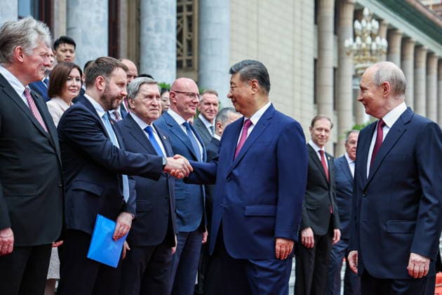 CHINA, BEIJING - MAY 20, 2026: Vladimir Putin, President of Russia, and his counterpart Xi Jinping (R-L front) of China greet Russia s Presidential Press Secretary Dmitry Peskov, Maxim Oreshkin, Deputy Chief of Staff, Presidential Executive Office, Presidential Aide Yuri Ushakov and Deputy Prime Minister Dmitry Chernyshenko (L-R front) during a welcoming ceremony in Tiananmen Square. Putin s official visit marks 25 years since the 2001 Treaty of Good Neighbourliness and Friendly Cooperation between Russia and China. Alexander Kazakov Russian Presidential Press and Information Office TASS  92771188
