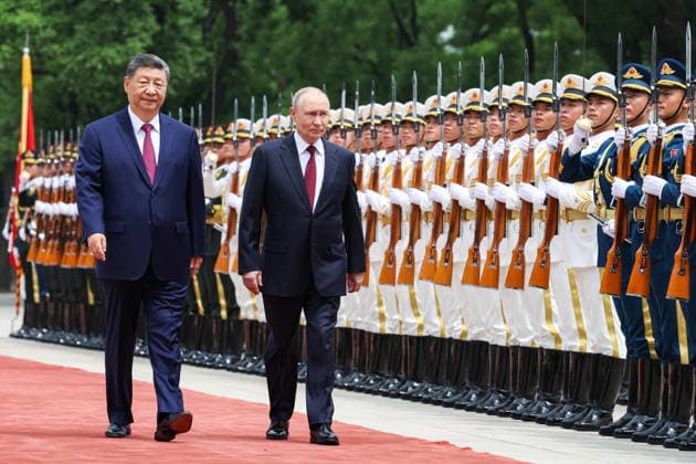 May 20, 2026, Beijing, China: XI JINPING, President of China, and his counterpart VLADIMIR PUTIN (L-R) of Russia walk past honour guards during a welcoming ceremony in Tiananmen Square. Putin s official visit marks 25 years since the 2001 Treaty of Good Neighbourliness and Friendly Cooperation between Russia and China Beijing China  - ZUMAt113 20260520_zaa_t113_016 Copyright: xAlexanderxKazakovx