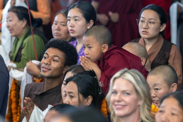 May 20, 2026, Palampur, Dharamshala, India: A novice monk and tibetan flowers watching Tibetan spiritual Leader the Dalai Lama (not in picture) leaving the temple after end of a long life prayer offered to him by Central Dokham Chushi Gangdrug and Himalayan Buddhist Cultural Association at the Main Tibetan Temple in Mcleodganj, Dharamshala ..NOTE: EDITORIAL USE ONLY. Palampur India  - ZUMAb235 20260520_zip_b235_009 Copyright: xShaileshxBhatnagarx
