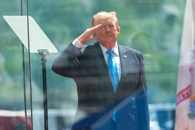 President Donald Trump salutes during the National Anthem before delivering the commencement address at the United States Coast Guard Academy s graduation ceremony in New London, Connecticut on Wednesday, May 20, 2026.  CONN20260520434 ANGELINAxKATSANIS