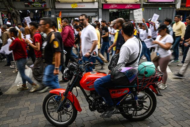 Protest for the release of political prisoners in Caracas CARACAS, VENEZUELA – MAY 20: A man on a motorcycle watches as a protest march of mothers, family members, students, and union workers passes by on their way to the headquarters of the Ministry of Popular Power for Penitentiary Services to demand the release of political prisoners and denounce deaths in state custody, in Caracas, Venezuela, May 20, 2026. Maxwell Briceno Anadolu Caracas Venezuela. Editorial use only. Please get in touch for any other usage.  Copyright: x2026xAnadoluxMaxwellxBricenox