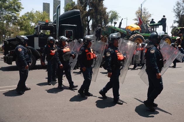 Transport workers and farmers lead rally in Mexico City MEXICO CITY, MEXICO - MAY 20: Riot police officers walk past tractors and vehicles used by farm workers during a rally to demand more security on highways, in Mexico City, Mexico on May 20, 2026. Under the slogan Without support for farmers, there will be no World Cup, hundreds of transport workers and farmers from several states across Mexico gathered to demand greater security nationwide, particularly on highways where criminal activity has increased, as well as more government support for the agricultural sector. Daniel Cardenas Anadolu Mexico City Mexico. Editorial use only. Please get in touch for any other usage.  Copyright: x2026xAnadoluxDanielxCardenasx