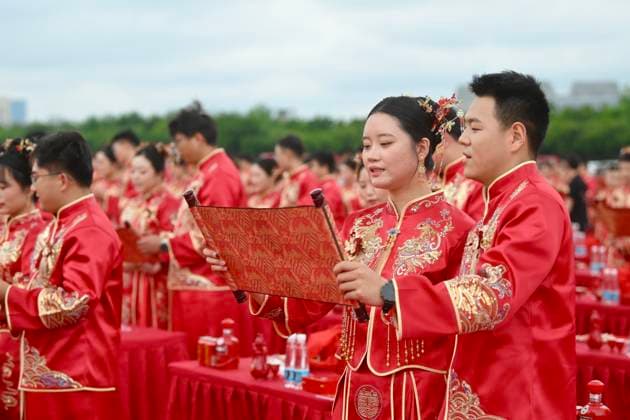 HEFEI, CHINA - MAY 20: Newly-wed couples in traditional Chinese-style clothing attend a group wedding ceremony during 520 I Love You Day on May 20, 2026 in Hefei, Anhui Province of China. Chinese people celebrate 520 I Love You Day as 520 sounds like I love you in Chinese.  Copyright: xChinaxNewsxServicex 111642851342