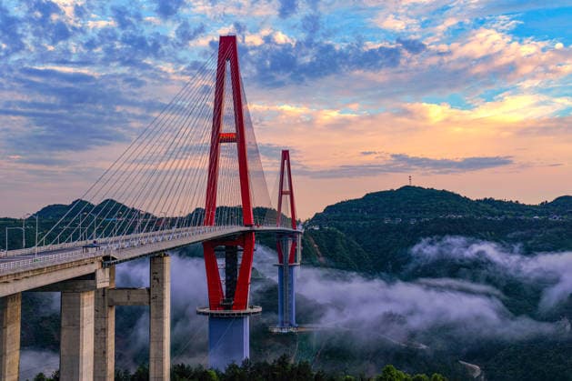 QIANNAN, CHINA - MAY 20: In an aerial view, morning glow shines over Longli River Bridge on May 20, 2026 in Longli County, Qiannan Bouyei and Miao Autonomous Prefecture, Guizhou Province of China.  Copyright: xVCGx 111642849418