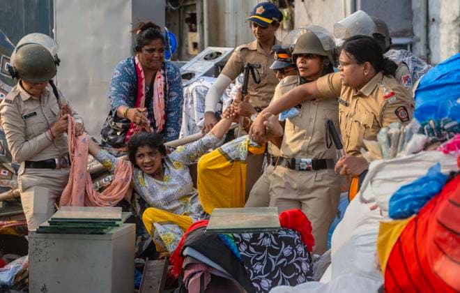 MUMBAI, INDIA - MAY 20: Police detain residents after clash on the second day of an anti-encroachment drive at Garib Nagar slum on railway land on May 20, 2026 in Mumbai, India. (Photo by Satish Bate Hindustan Times) Second Day Of Demolition Drive At Bandra Garib Nagar