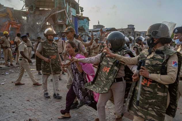 MUMBAI, INDIA - MAY 20: Police detain residents after clash on the second day of an anti-encroachment drive at Garib Nagar slum on railway land on May 20, 2026 in Mumbai, India. (Photo by Satish Bate Hindustan Times) Second Day Of Demolition Drive At Bandra Garib Nagar