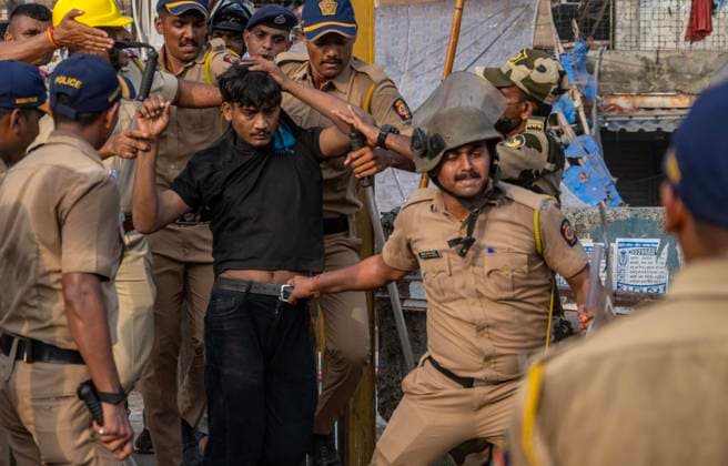 MUMBAI, INDIA - MAY 20: Police detain residents after clash on the second day of an anti-encroachment drive at Garib Nagar slum on railway land on May 20, 2026 in Mumbai, India. (Photo by Satish Bate Hindustan Times) Second Day Of Demolition Drive At Bandra Garib Nagar