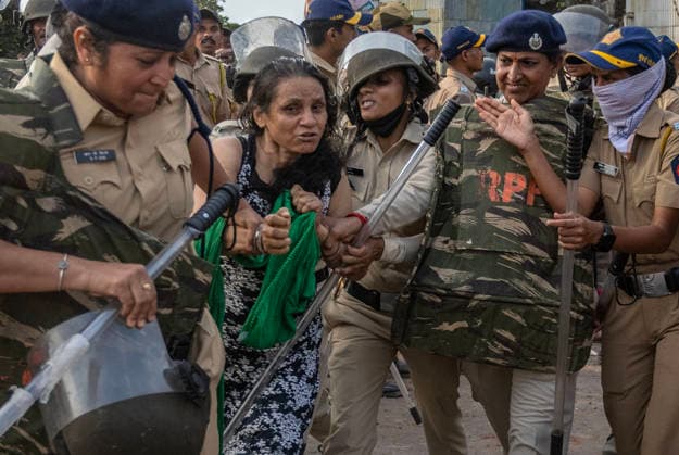 MUMBAI, INDIA - MAY 20: Police detain residents after clash on the second day of an anti-encroachment drive at Garib Nagar slum on railway land on May 20, 2026 in Mumbai, India. (Photo by Satish Bate Hindustan Times) Second Day Of Demolition Drive At Bandra Garib Nagar