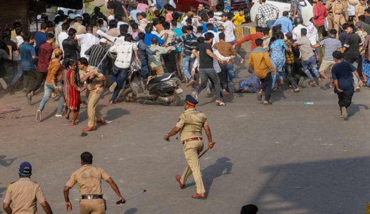 MUMBAI, INDIA - MAY 20: Police use lathi charge to disperse residents after stone pelting on the second day of an anti-encroachment drive at Garib Nagar slum on railway land on May 20, 2026 in Mumbai, India. (Photo by Satish Bate Hindustan Times) Second Day Of Demolition Drive At Bandra Garib Nagar