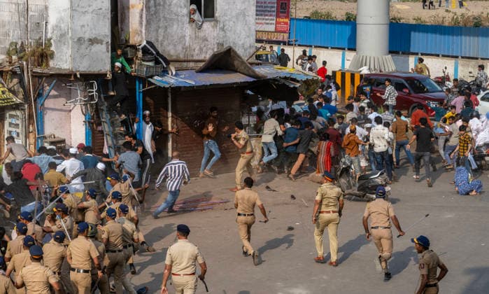 MUMBAI, INDIA - MAY 20: Police use lathi charge to disperse residents after stone pelting on the second day of an anti-encroachment drive at Garib Nagar slum on railway land on May 20, 2026 in Mumbai, India. (Photo by Satish Bate Hindustan Times) Second Day Of Demolition Drive At Bandra Garib Nagar