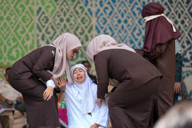 May 21, 2026, Kuta Alam, Banda Aceh, Indonesia: Officers assist a Sharia violator for adultery who is in pain after receiving 100 lashes in Banda Aceh, Aceh Province, Indonesia, on Thursday. The caning was imposed after being found guilty of violating Sharia law in Aceh. The public caning serves as a form of education and transparency in the implementation of punishment, guaranteed by the Aceh Qanun (Aceh Law), which was passed in 2014. Kuta Alam Indonesia  - ZUMAi115 20260521_zip_i115_038 Copyright: xMuhammadxIqbalx