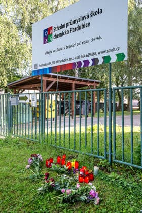 A memorial place with flowers and candles at the entrance to the secondary technical school of chemistry where a female student died after being attacked on May 21, pictured on May 22, 2026, in Pardubice, Czech Republic. Police detained the suspected assailant after the incident. (CTKxPhoto DavidxTanecek) CTKPhotoP2026052201798  CTKPhotoP2026052201798