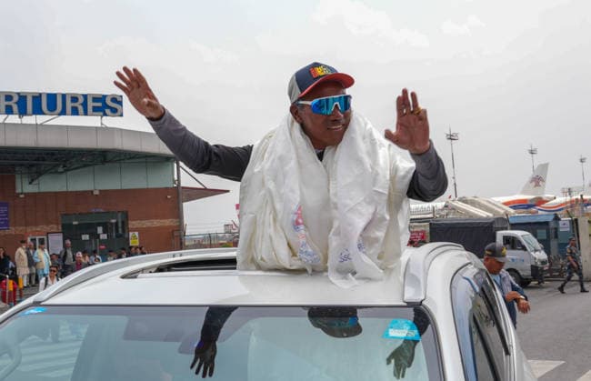 Record holder mountaineer, Kami Rita Sherpa arrived at Tribhuvan International Airport in Kathmandu in Nepal - 22 MAY 2026. Mountaineer and guide, Kami Rita Sherpa seen waving to people as he was leaving Tribhuvan International Airport after setting a new record by successfully scaling Mount Everest for the 32nd time. Kathmandu Nepal Copyright: xSunilxPradhanx xSOPAxImagesx DSC02438