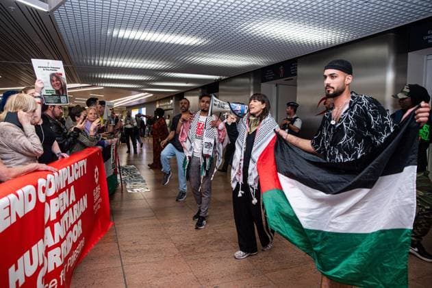 Pro-Palestinian activists pictured before Belgian activists who were part of the Gaza Flotilla arrive at Brussels Airport, in Zaventem, Friday 22 May 2026.  EMILExWINDAL 174749058