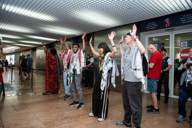 Pro-Palestinian activists pictured before Belgian activists who were part of the Gaza Flotilla arrive at Brussels Airport, in Zaventem, Friday 22 May 2026.  EMILExWINDAL 174749214