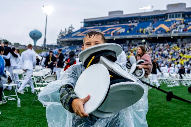Children collect caps after the U.S. Naval Academy Graduation and Commissioning Ceremony at the U.S. Naval Academy in Annapolis, Maryland on Friday, May 22, 2026. The Naval Academy has a total of 1059 graduates.  ANN20260522348 BONNIExCASH