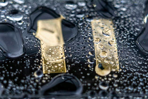 Gold Midshipmen insignia, given to Naval Academy graduates, is seen in a rain covered box after the U.S. Naval Academy Graduation and Commissioning Ceremony at the U.S. Naval Academy in Annapolis, Maryland on Friday, May 22, 2026. The Naval Academy has a total of 1059 graduates.  ANN20260522350 BONNIExCASH