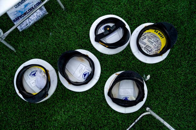 Caps are seen on the ground after the U.S. Naval Academy Graduation and Commissioning Ceremony at the U.S. Naval Academy in Annapolis, Maryland on Friday, May 22, 2026. The Naval Academy has a total of 1059 graduates.  ANN20260522351 BONNIExCASH