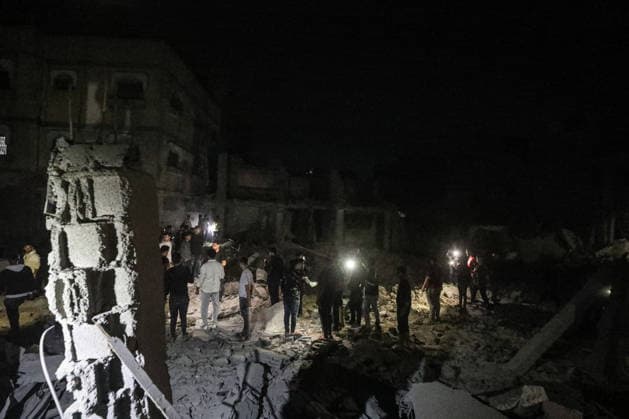 Israeli army continues attacking Gaza despite ceasefire BUREIJ, GAZA, PALESTINE - MAY 22: Palestinians inspect the destruction amid the rubble of destroyed buildings following heavy Israeli air strikes targeting the Nuseirat and Bureij refugee camps in the central Gaza Strip, Palestine on May 22, 2026. The aerial bombardments completely flattened several residential structures and caused extensive damage to neighboring homes, leaving a large number of civilians injured. Moiz Salhi Anadolu Bureij Gaza. Editorial use only. Please get in touch for any other usage.  Copyright: x2026xAnadoluxMoizxSalhix