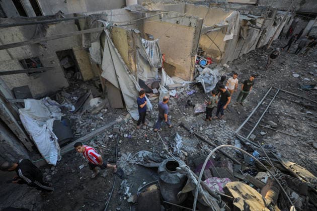 Israeli army continues attacking Gaza despite ceasefire GAZA CITY, GAZA, PALESTINE - MAY 22: Palestinians inspect the destruction amid the rubble of buildings following Israeli military strikes targeting the Abu Saif family home despite the ongoing ceasefire in Nuseirat Refugee Camp, Gaza City, Gaza, Palestine on May 22, 2026. Hassan Jedi Anadolu Gaza City Gaza. Editorial use only. Please get in touch for any other usage.  Copyright: x2026xAnadoluxHassanxJedix