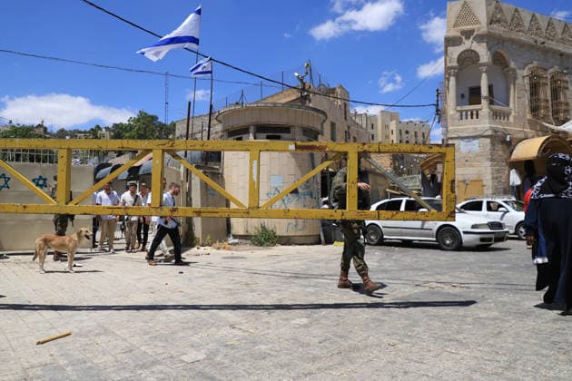 Israeli forces block entrances with iron barriers during settler raid in Hebron HEBRON, PALESTINE - MAY 23: Israeli settlers, under the protection of Israeli forces, raid the Old City area of Hebron in the southern West Bank, Palestine, on May 23, 2026. Blocking entrances and exits with iron barriers during the raid, Israeli forces restricted the movement of Palestinians. Amer Shallodi Anadolu Hebron West Bank. Editorial use only. Please get in touch for any other usage.  Copyright: x2026xAnadoluxAmerxShallodix