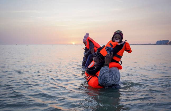 May 23, 2026, Dunkirk, Nord, France: Dunkirk, France. A family of migrants in the sea after failing to board an inflatable boat at the beach at Dunkirk, while attempting to cross the English Channel. More than 200,000 migrants have crossed the Channel in small boats since 2018. Dunkirk France  - ZUMAl94_ 20260523_zaf_l94_058 Copyright: xIoannisxAlexopoulosx