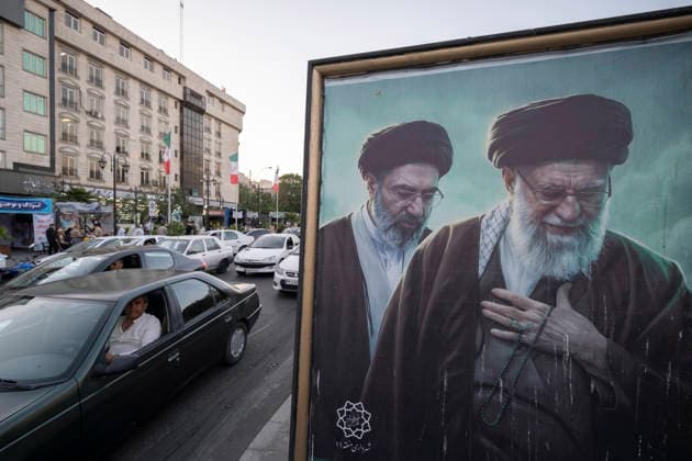 Daily Life In Iran Amid Threat About New Possible War Vehicles drive past portraits of Iran s late and new Supreme Leaders Ayatollah Ali Khamenei and Ayatollah Mojtaba Khamenei in a business district in downtown Tehran, Iran, on May 22, 2026. U.S. President Donald Trump has indicated the possibility of military action against Iran if no agreement is reached with Iranian officials. Tehran Tehran Iran  Copyright: xMortezaxNikoubazlx originalFilename: nikoubazl-dailylif260522_npv8h.jpg