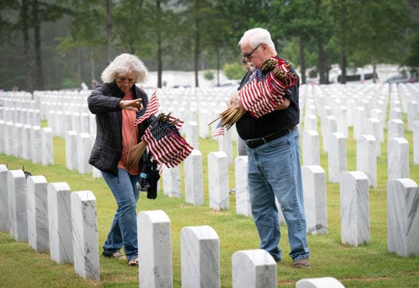 May 23, 2026, Canton, Georgia, USA: A husband and wife join volunteers to place U.S. flags on veteransÃ¢â‚¬â ¢ graves during Memorial Day celebration at the Georgia National Cemetery. Canton USA - ZUMAn03_ 20260523_zaf_n03_003 Copyright: xRobinxRaynex