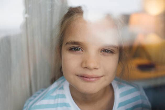 Ein lächelndes achtjähriges Mädchen schaut zu Hause aus dem Fenster smiling little girl of eight looks out the window at home (License=RF) ,model released, Symbolfoto Copyright: xZoonar.com UliaxZotaninax 25039516 ,model released, Symbolfoto ,property released