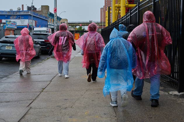 May 23, 2026, New York, New York, USA: A group of people wearing rain ponchos are among the sparse visitors on a dreary, stormy day marking the official opening of the 2026 Summer beach season in Coney Island, Brooklyn. New York USA  - ZUMAl171 20260523_znp_l171_004 Copyright: xEdnaxLeshowitzx
