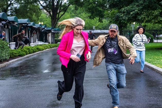 Reporters run for cover following reports of alleged gun fire near the White House in Washington, DC on Saturday, May 23, 2026. A man was shot by US Secret Service agents near the White House on Saturday after he opened fire with a handgun, according to a person familiar with the matter.  WASP20260523119 AaronxSchwartz