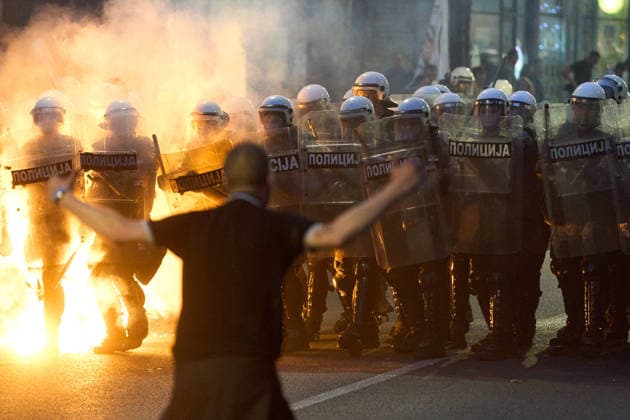 May 23, 2026, Belgrade, Central Serbia, Serbia: 2026523, Belgrade, Serbia - A large number of citizens answer the call of university students and gather to protest in the center of Belgrade. A demonstrator stands in front of a line of riot police as a fire burns during the clashes. Belgrade Serbia - ZUMAd223 20260523_zip_d223_012 Copyright: xMarkoxDimicx
