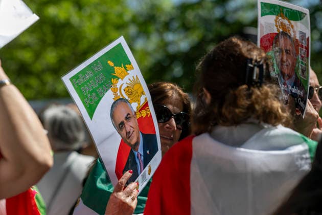 May 24, 2026, Stockholm, Sweden: Anti-Iranian regime protesters gather outside the Iranian Embassy in Stockholm, Sweden, on May 24, 2026, calling on Sweden to close the embassy and demanding restored internet access in Iran. Some demonstrators carried flags and signs in support of Reza Pahlavi. During the protest, participants staged a symbolic performance depicting imprisoned women confronting captured clerics, while chanting slogans against the Iranian regime and the ruling mullahs. Sweden - ZUMAa136 20260524_zap_a136_014 Copyright: xJoelxLindhex