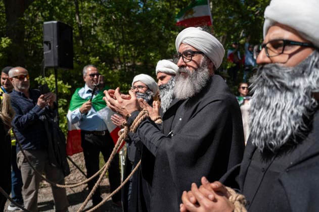 May 24, 2026, Stockholm, Sweden: Anti-Iranian regime protesters gather outside the Iranian Embassy in Stockholm, Sweden, on May 24, 2026, calling on Sweden to close the embassy and demanding restored internet access in Iran. Some demonstrators carried flags and signs in support of Reza Pahlavi. During the protest, participants staged a symbolic performance depicting imprisoned women confronting captured clerics, while chanting slogans against the Iranian regime and the ruling mullahs. Sweden - ZUMAa136 20260524_zap_a136_025 Copyright: xJoelxLindhex