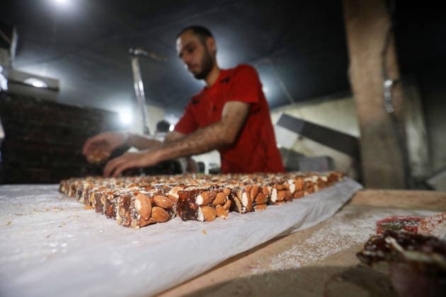 Palestinian workers produce traditional sweets ahead of Eid al-Adha Palestinian workers continued producing the traditional sweet known locally as Halakum at a factory in the Al-Daraj neighborhood, east of Gaza City, on May 24, 2026, ahead of Eid al-Adha. The factory resumed operations with limited resources after sustaining damage from Israeli airstrikes during the war. Halakum is a traditional sweet widely consumed during holidays, and the factory strives to provide it to residents despite the difficult living conditions and sharp decline in purchasing power in the Gaza Strip before Eid al-Adha. Photo by Bilal Osama apaimages Gaza city Gaza Strip Palestinian Territory 240526_Gaza_BO_01(32) Copyright: xapaimagesxBilalxOsamax xapaimagesx