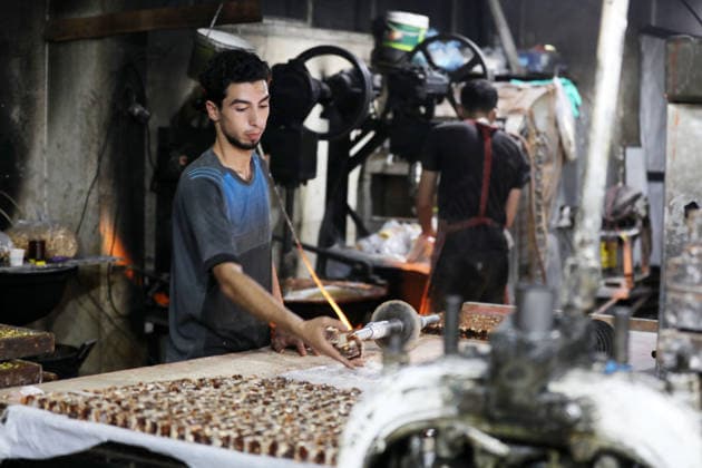 Palestinian workers produce traditional sweets ahead of Eid al-Adha Palestinian workers continued producing the traditional sweet known locally as Halakum at a factory in the Al-Daraj neighborhood, east of Gaza City, on May 24, 2026, ahead of Eid al-Adha. The factory resumed operations with limited resources after sustaining damage from Israeli airstrikes during the war. Halakum is a traditional sweet widely consumed during holidays, and the factory strives to provide it to residents despite the difficult living conditions and sharp decline in purchasing power in the Gaza Strip before Eid al-Adha. Photo by Bilal Osama apaimages Gaza city Gaza Strip Palestinian Territory 240526_Gaza_BO_01(35) Copyright: xapaimagesxBilalxOsamax xapaimagesx