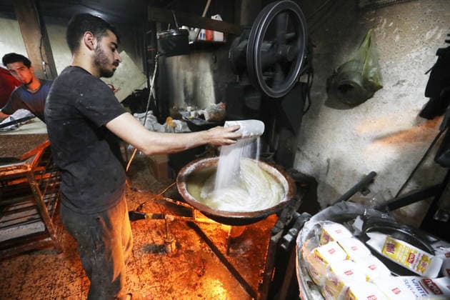 Palestinian workers produce traditional sweets ahead of Eid al-Adha Palestinian workers continued producing the traditional sweet known locally as Halakum at a factory in the Al-Daraj neighborhood, east of Gaza City, on May 24, 2026, ahead of Eid al-Adha. The factory resumed operations with limited resources after sustaining damage from Israeli airstrikes during the war. Halakum is a traditional sweet widely consumed during holidays, and the factory strives to provide it to residents despite the difficult living conditions and sharp decline in purchasing power in the Gaza Strip before Eid al-Adha. Photo by Bilal Osama apaimages Gaza city Gaza Strip Palestinian Territory 240526_Gaza_BO_01(4) Copyright: xapaimagesxBilalxOsamax xapaimagesx