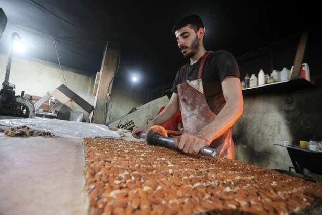 Palestinian workers produce traditional sweets ahead of Eid al-Adha Palestinian workers continued producing the traditional sweet known locally as Halakum at a factory in the Al-Daraj neighborhood, east of Gaza City, on May 24, 2026, ahead of Eid al-Adha. The factory resumed operations with limited resources after sustaining damage from Israeli airstrikes during the war. Halakum is a traditional sweet widely consumed during holidays, and the factory strives to provide it to residents despite the difficult living conditions and sharp decline in purchasing power in the Gaza Strip before Eid al-Adha. Photo by Bilal Osama apaimages Gaza city Gaza Strip Palestinian Territory 240526_Gaza_BO_01(7) Copyright: xapaimagesxBilalxOsamax xapaimagesx