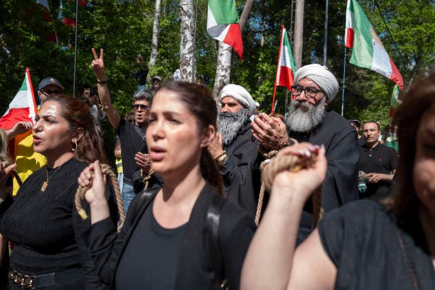 May 24, 2026, Stockholm, Sweden: Anti-Iranian regime protesters gather outside the Iranian Embassy in Stockholm, Sweden, on May 24, 2026, calling on Sweden to close the embassy and demanding restored internet access in Iran. Some demonstrators carried flags and signs in support of Reza Pahlavi. During the protest, participants staged a symbolic performance depicting imprisoned women confronting captured clerics, while chanting slogans against the Iranian regime and the ruling mullahs. Sweden  - ZUMAa136 20260524_zap_a136_030 Copyright: xJoelxLindhex