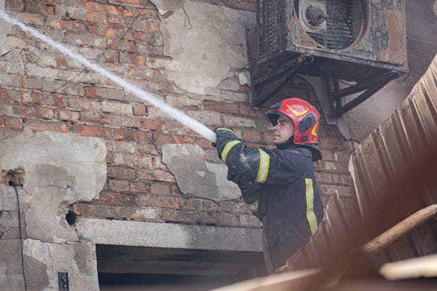 Ukraine Kyiv Shopping Centre Strike Aftermath A Ukrainian firefighter works with water hoses at the site of a heavily damaged shopping centre in Kyiv, Ukraine, on May 24, 2026, after Russian strikes. A large-scale Russian missile and drone attack hit Kyiv early on May 24 in what Moscow said was retaliation for strikes in Russian-occupied eastern Ukraine, with at least two people killed and more than 77 injured, including children. Kyiv Kyiv Ukraine Copyright: xOrixAviramx