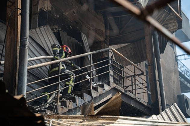 Ukraine Kyiv Shopping Centre Strike Aftermath A Ukrainian firefighter works with water hoses at the site of a heavily damaged shopping centre in Kyiv, Ukraine, on May 24, 2026, after Russian strikes. A large-scale Russian missile and drone attack hit Kyiv early on May 24 in what Moscow said was retaliation for strikes in Russian-occupied eastern Ukraine, with at least two people killed and more than 77 injured, including children. Kyiv Kyiv Ukraine Copyright: xOrixAviramx