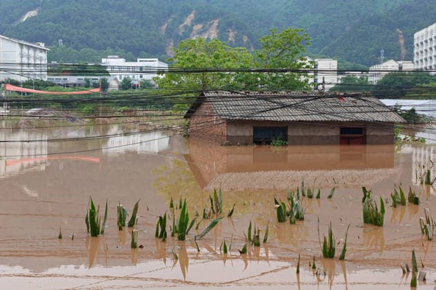 CHONGQING, CHINA - MAY 24: Houses and crops are submerged after extreme rainfalls trigger flash floods and geological disasters on May 24, 2026 in Yongchuan District, Chongqing City, China. Devastating rainstorms struck parts of Southwest China s Chongqing over the weekend, resulting in multiple casualties and missing people in the municipality s Yongchuan and Beibei districts. Rescue efforts are ongoing. As of 2:30 pm on May 24, local authorities reported three deaths and 17 people missing in Yongchuan, with another two people missing in Beibei.  Copyright: xChinaxNewsxServicex 111643812941