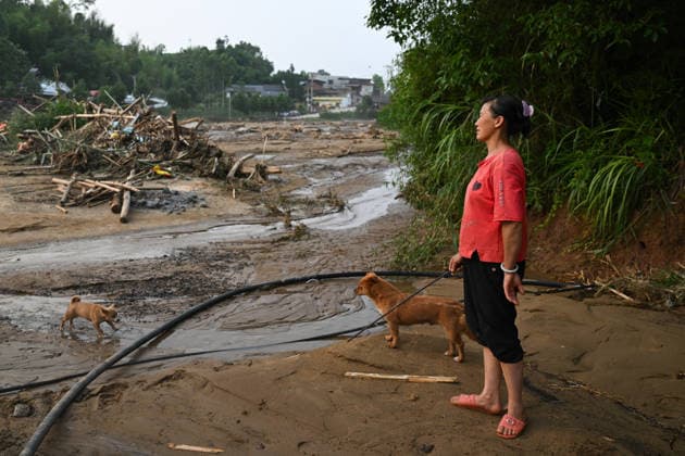 CHONGQING, CHINA - MAY 24: A villager looks at the disaster-hit area after extreme rainfalls trigger flash floods and geological disasters on May 24, 2026 in Yongchuan District, Chongqing City, China. Devastating rainstorms struck parts of Southwest China s Chongqing over the weekend, resulting in multiple casualties and missing people in the municipality s Yongchuan and Beibei districts. Rescue efforts are ongoing. As of 2:30 pm on May 24, local authorities reported three deaths and 17 people missing in Yongchuan, with another two people missing in Beibei.  Copyright: xChinaxNewsxServicex 111643846475