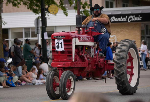 (260525) -- DELTA, May 25, 2026 -- A man drives a tractor on the street during the Ladner May Days parade in Ladner, British Columbia, Canada, May 24, 2026. (Photo by Xinhua) CANADA-BRITISH COLUMBIA-LADNER-MAY DAYS PARADE LiangxSen 